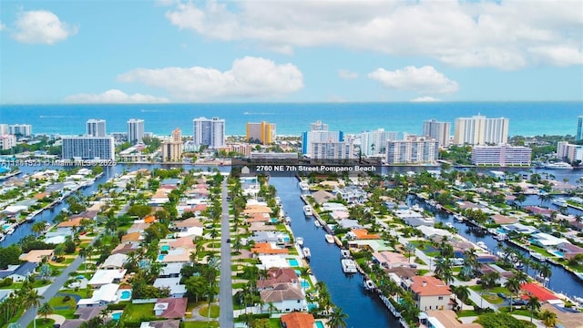 birds eye view of property featuring a water view and a city view