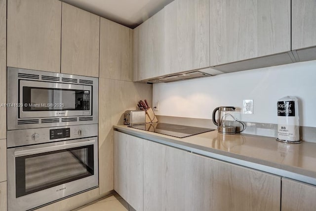 kitchen with appliances with stainless steel finishes and light brown cabinetry