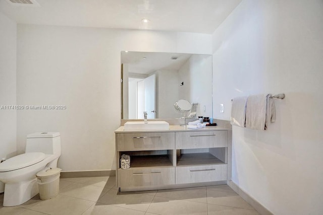 bathroom with vanity, tile patterned flooring, and toilet