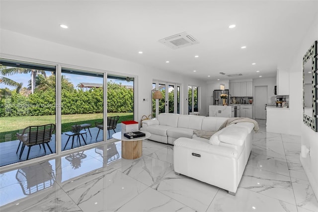 living room featuring marble finish floor and recessed lighting