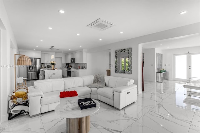 living room with marble finish floor, visible vents, and recessed lighting