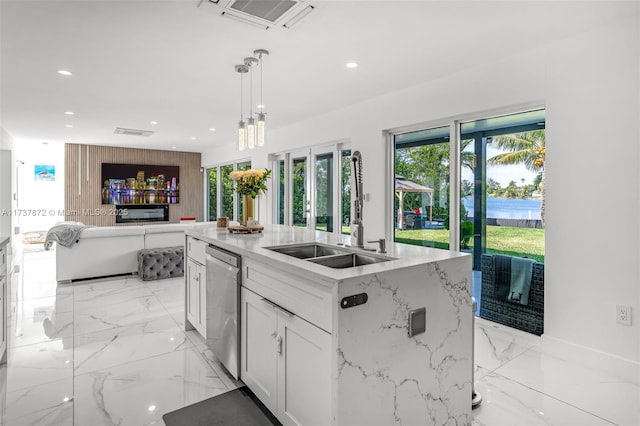 kitchen with a sink, marble finish floor, visible vents, and dishwasher