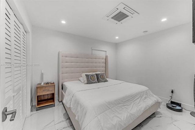 bedroom with baseboards, marble finish floor, and recessed lighting