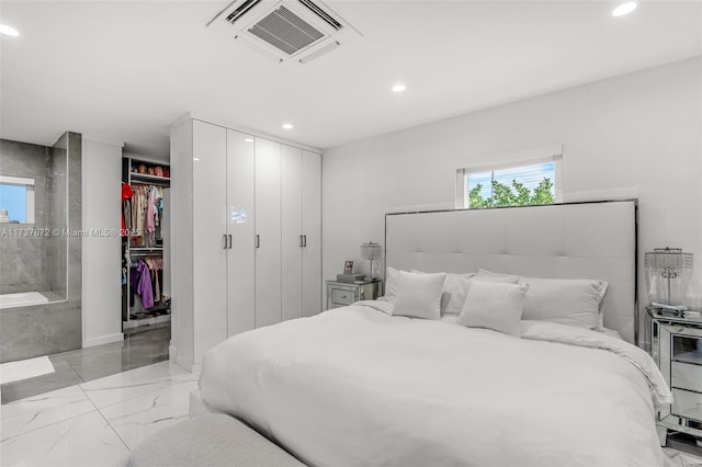 bedroom with a closet, recessed lighting, marble finish floor, and visible vents