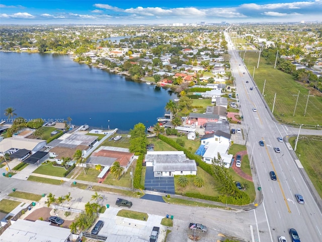 drone / aerial view with a water view and a residential view