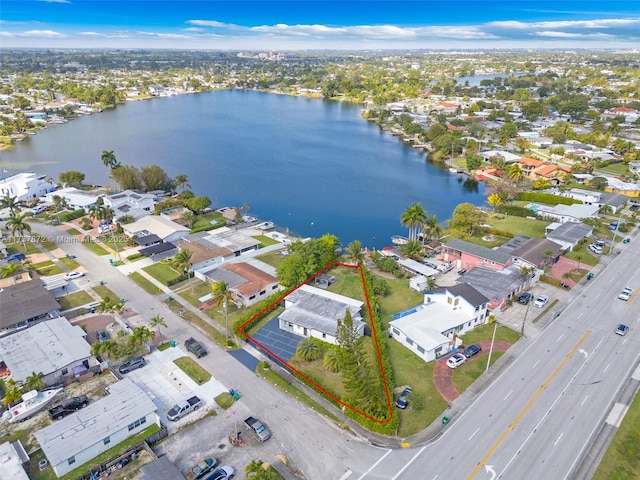 drone / aerial view with a water view and a residential view