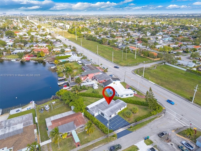 birds eye view of property with a water view and a residential view