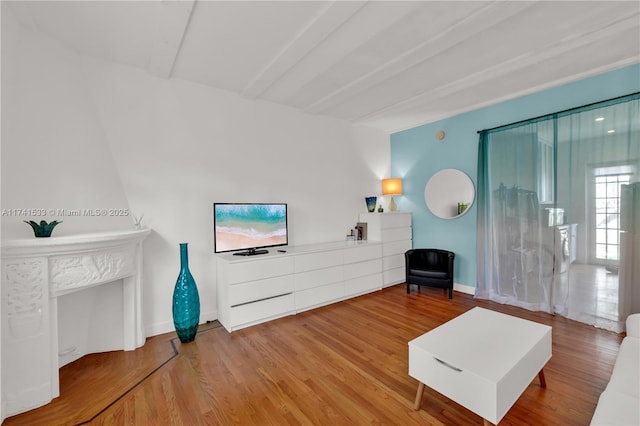 living room featuring hardwood / wood-style flooring and beamed ceiling