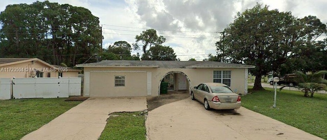 ranch-style home with a front lawn