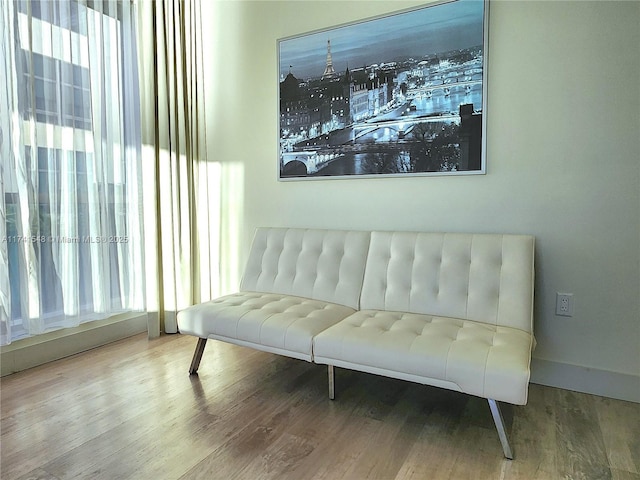 living area with hardwood / wood-style floors