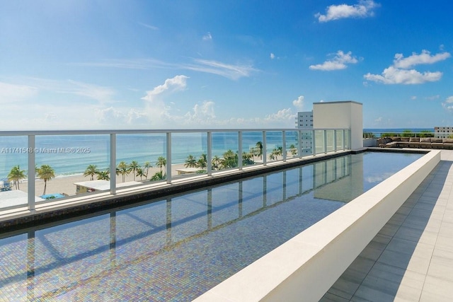 view of pool with a water view