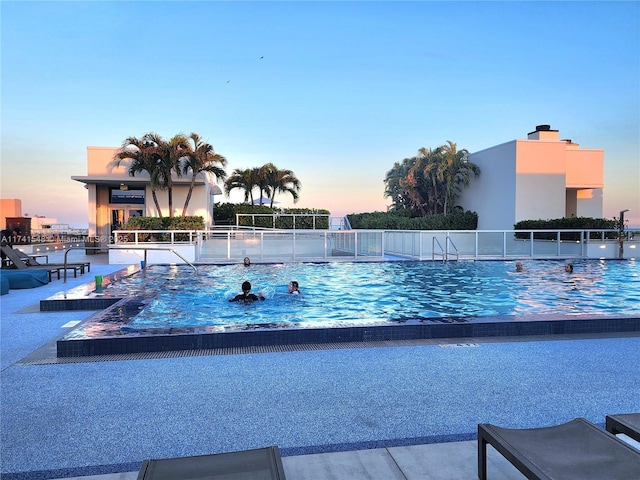 view of pool at dusk