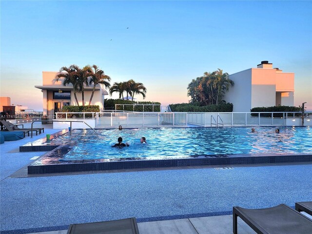 777 N Ocean Dr Unit S401, Hollywood, FL 33019 - pool at dusk with a patio and a community pool
