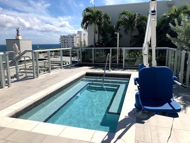 view of swimming pool featuring a water view