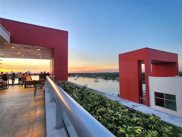 balcony at dusk with a water view