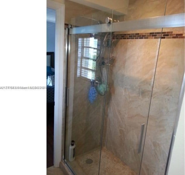 bathroom featuring a shower stall