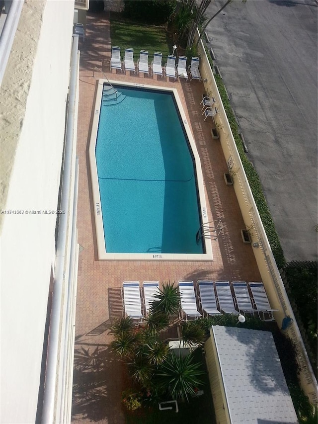 community pool with a patio area