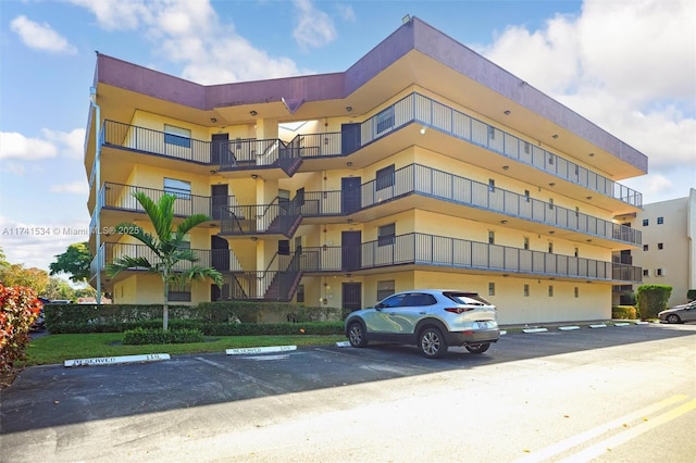 view of building exterior featuring uncovered parking