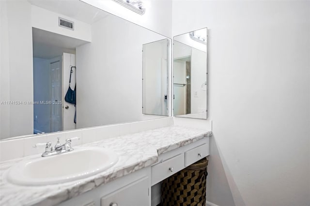 bathroom with visible vents and vanity