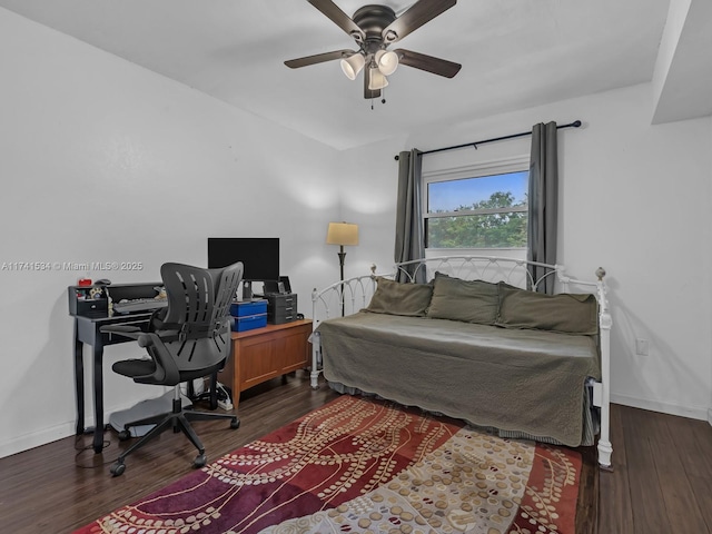 bedroom with dark wood-style floors, a ceiling fan, and baseboards