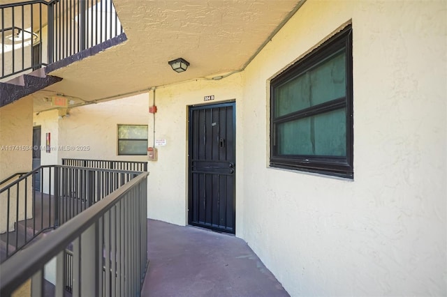 entrance to property with stucco siding