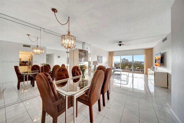 1985 S Ocean Dr Unit 22G, Hallandale Beach, FL 33009 - dining space featuring light tile patterned flooring, a chandelier, and a textured ceiling