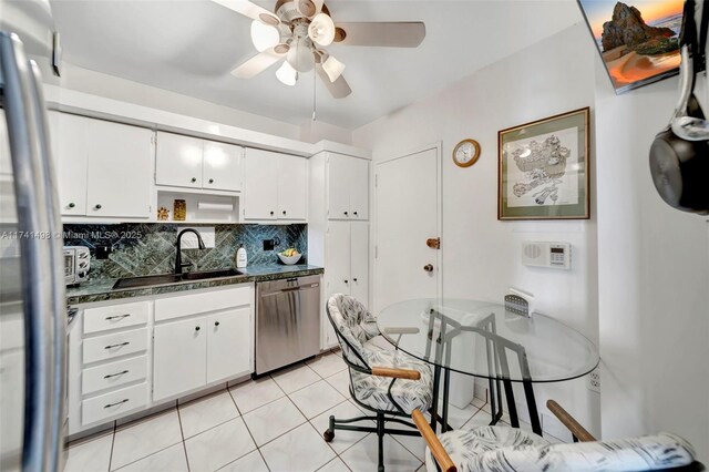 1985 S Ocean Dr Unit 22G, Hallandale Beach, FL 33009 - kitchen featuring sink, white cabinetry, light tile patterned floors, stainless steel dishwasher, and backsplash
