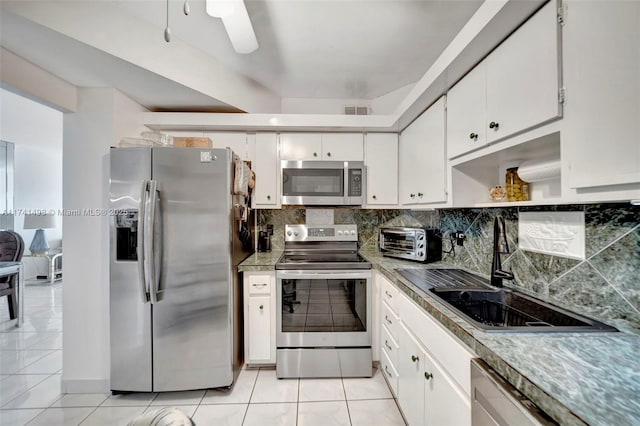 1985 S Ocean Dr Unit 22G, Hallandale Beach, FL 33009 - kitchen featuring white cabinetry, sink, backsplash, and appliances with stainless steel finishes