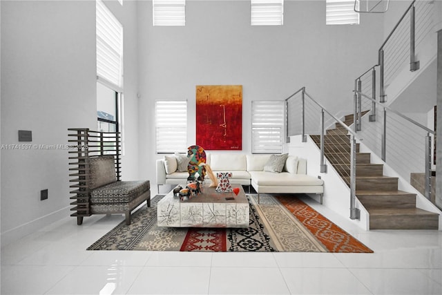 living room featuring a high ceiling, tile patterned flooring, and a wealth of natural light