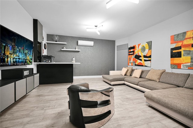 living room featuring a wall mounted air conditioner and light hardwood / wood-style floors