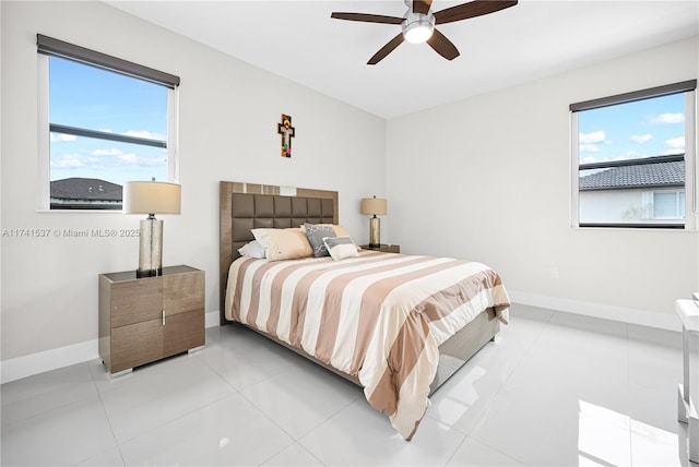 tiled bedroom featuring ceiling fan