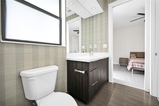 bathroom with ceiling fan, vanity, toilet, and tile patterned flooring