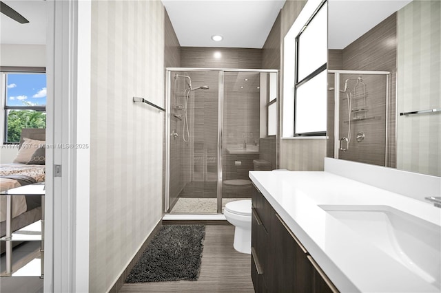 bathroom with vanity, toilet, and walk in shower