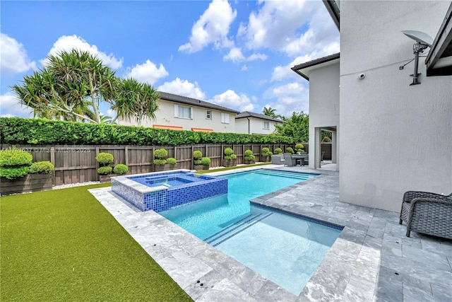 view of swimming pool featuring a patio area, a lawn, and an in ground hot tub