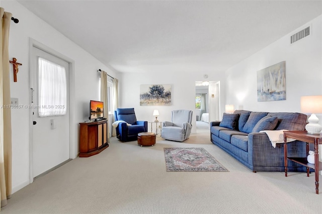 living room with carpet flooring and a wealth of natural light