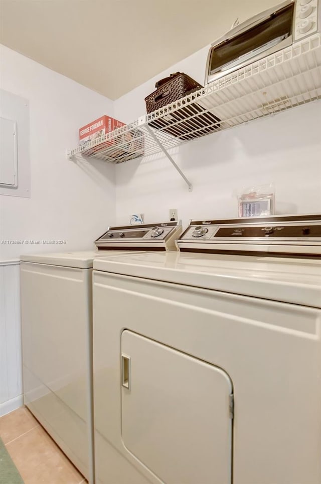 laundry room with light tile patterned flooring, separate washer and dryer, and electric panel