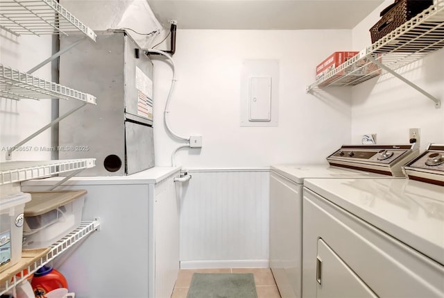 laundry room featuring electric panel, independent washer and dryer, and light tile patterned flooring