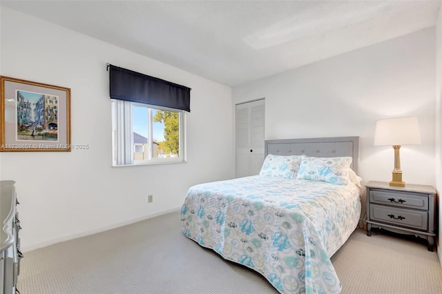 bedroom with light carpet and a closet