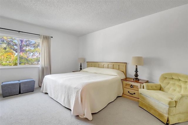 carpeted bedroom featuring a textured ceiling