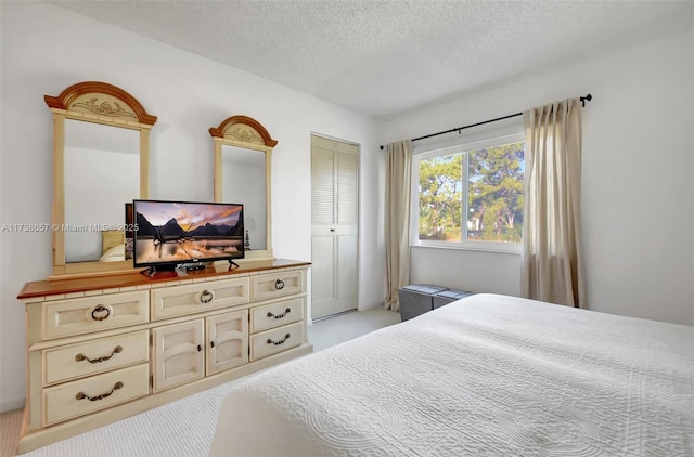 carpeted bedroom featuring a closet and a textured ceiling