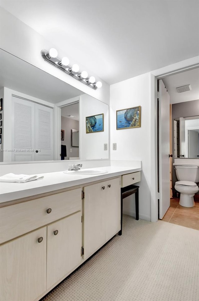 bathroom featuring vanity and toilet