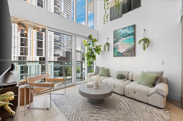 tiled living room featuring a high ceiling