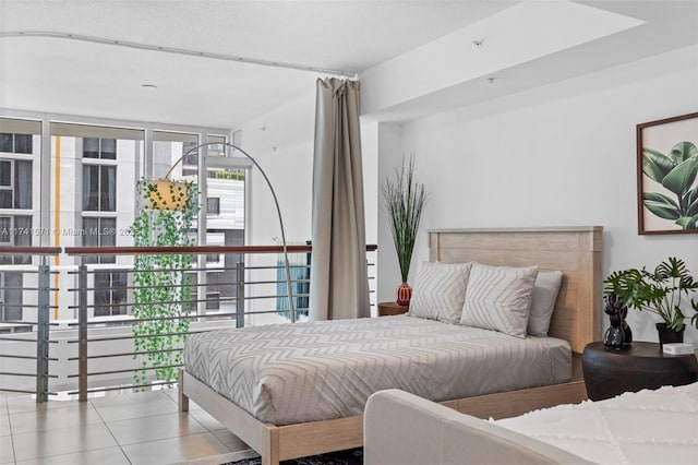 bedroom with light tile patterned flooring and floor to ceiling windows