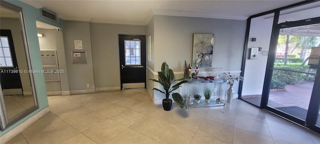 entryway featuring crown molding and light tile patterned flooring