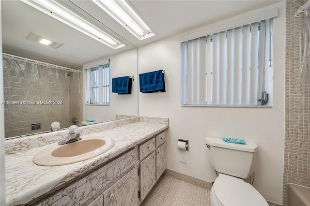 bathroom with vanity, curtained shower, tile patterned floors, and toilet