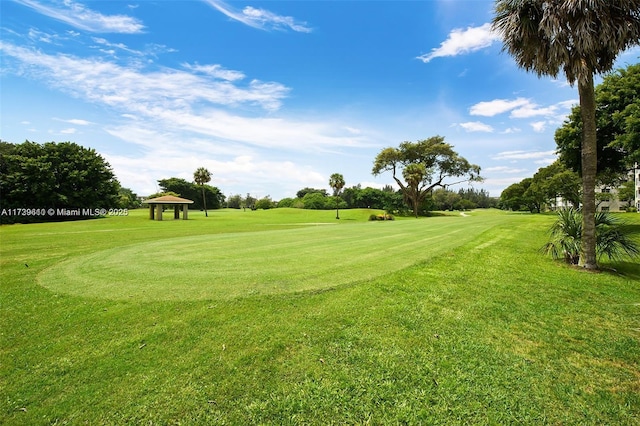 view of property's community with a gazebo and a yard