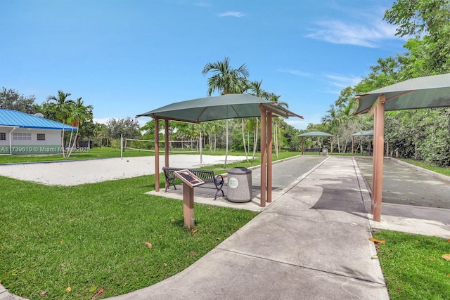 surrounding community with a gazebo, a lawn, and volleyball court