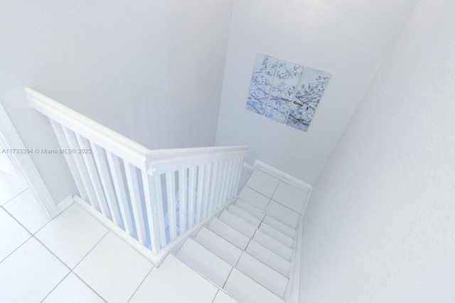 staircase featuring tile patterned floors