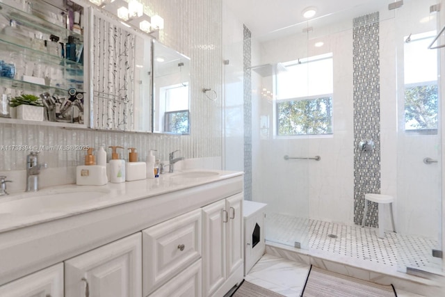 bathroom featuring a healthy amount of sunlight, tile walls, vanity, and a tile shower