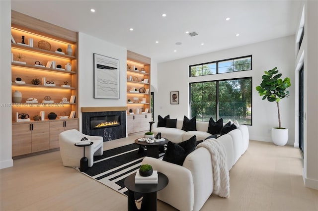 living room featuring light hardwood / wood-style floors and built in features